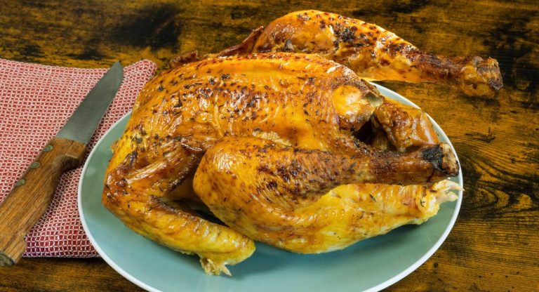 Volaille entière rôtie et dorée servie sur un plat